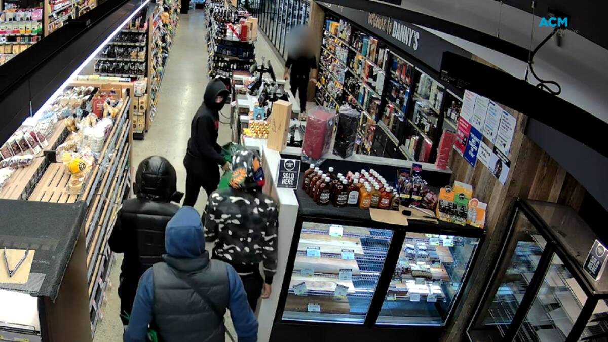 Four alleged thieves captured on CCTV entering a Melbourne IGA armed with knives and an axe. Picture supplied