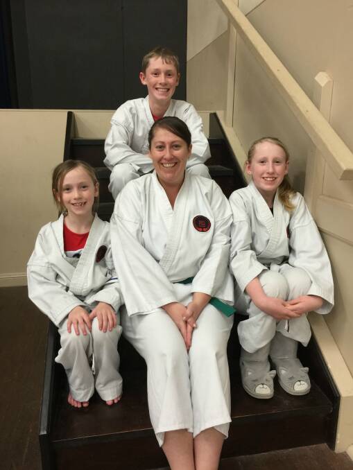 KARATE FAMILY: Allison surrounded by her children Bowen, Phoebe and Bethany. Photo Bronwyn Haynes.